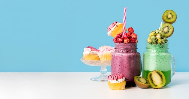 Front view of jars with dessert and fruits