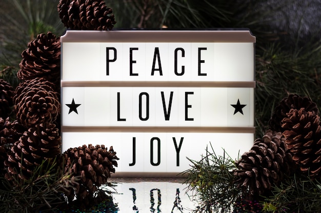 Free photo front view joy love peace christmas lettering