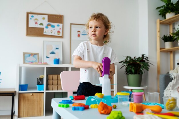 Front view kid playing with toy