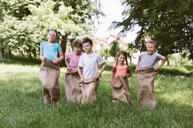 Front view kids competing in burlap bags