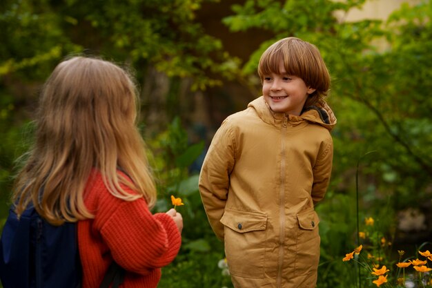 Free photo front view kids exploring nature together