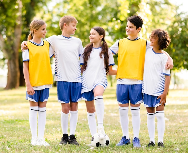 Front view kids in football sportswear looking at each other