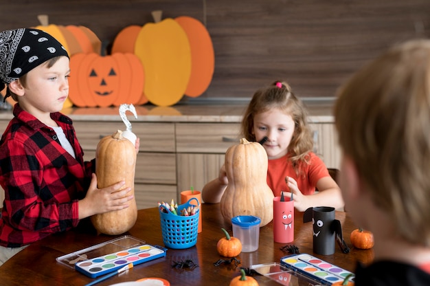 Front view of kids with halloween concept arrangements