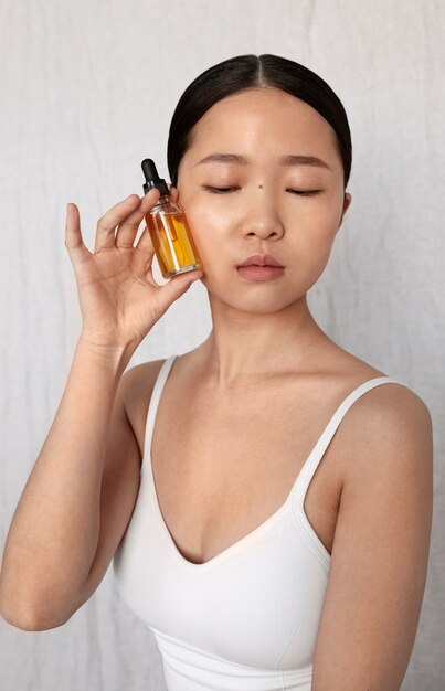 Front view korean woman posing with serum