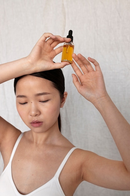 Front view korean woman posing with serum