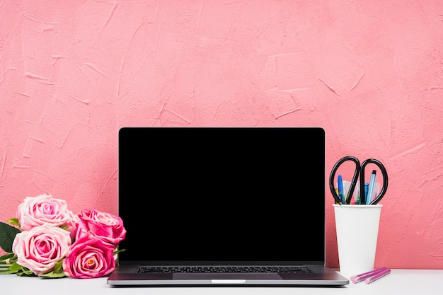 Front view laptop with bouquet of roses