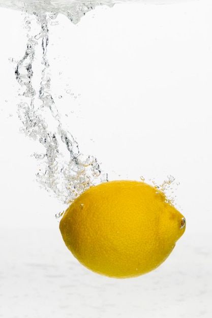 Front view of lemon in water with copy space