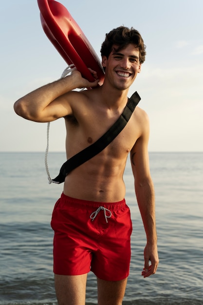 Free photo front view lifeguard holding lifesaving buoy