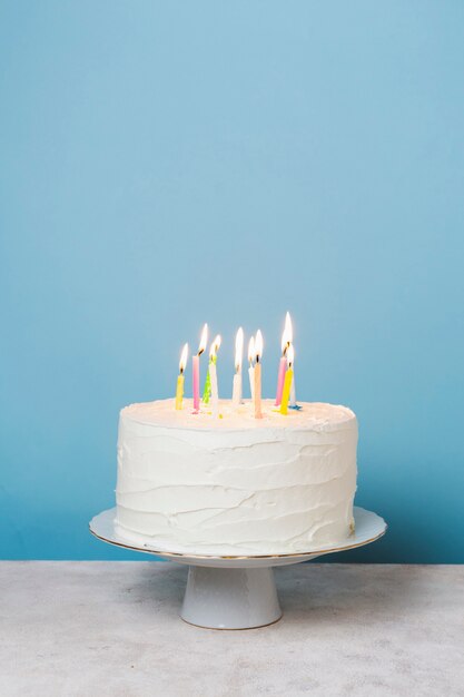 Front view lit candles on birthday cake