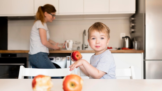 Front view of little boy cooking at home