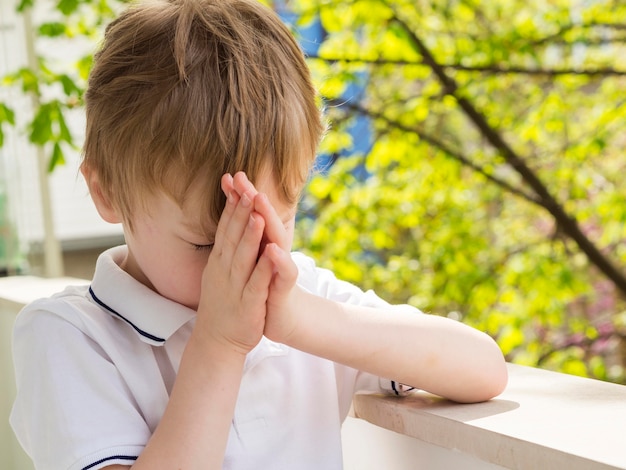 Front view of little boy praying