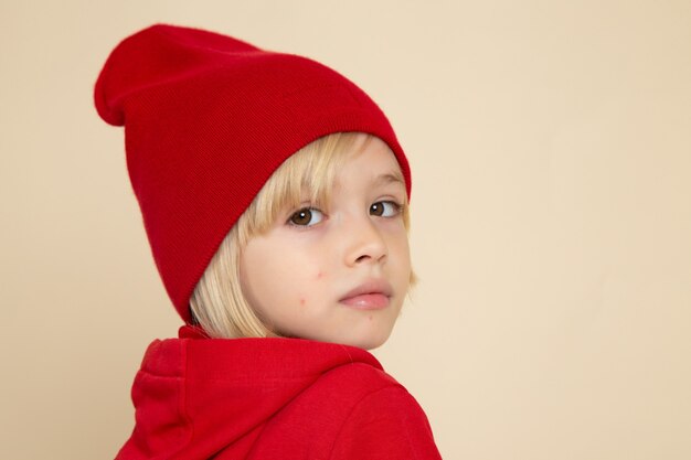 Free Photo front view little cute boy in red shirt and hat