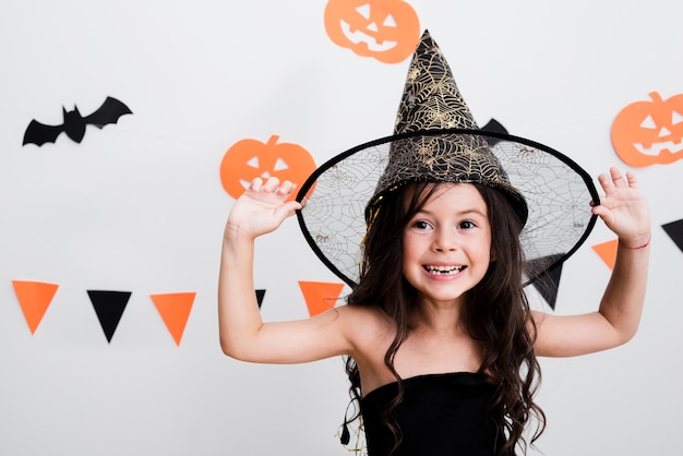 Front view little girl in witch costume for halloween