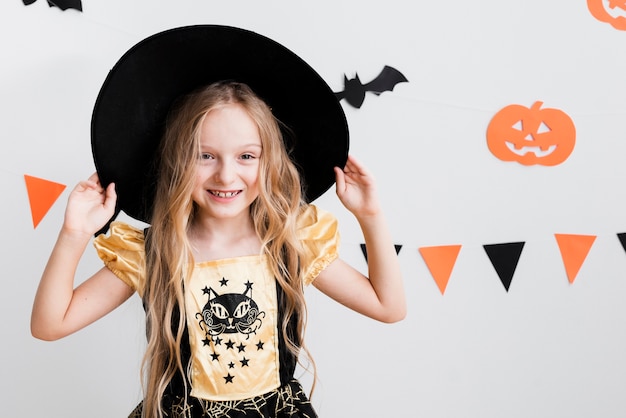 Front view little girl in witch costume for halloween