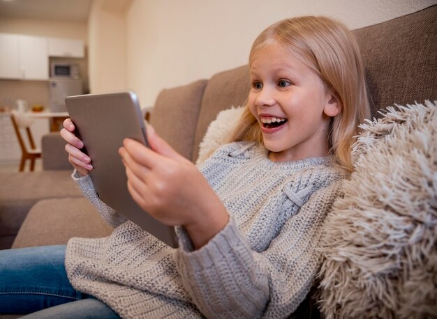 Front view of little girl with tablet