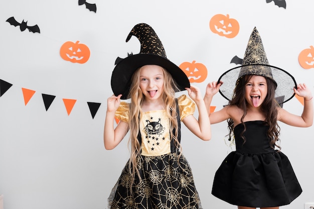 Front view little girls in witch costume for halloween