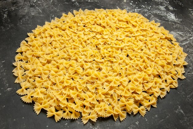 Front view little raw pasta on dark many dough food meal color italian pasta photo