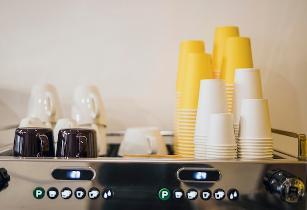 Free Photo front view of loads of cups and coffee machine