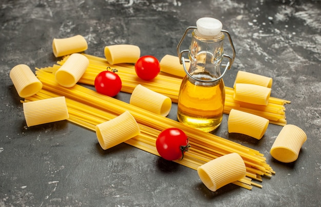 Free Photo front view long italian pasta with red tomatoes on light-grey food color dough cuisine meal