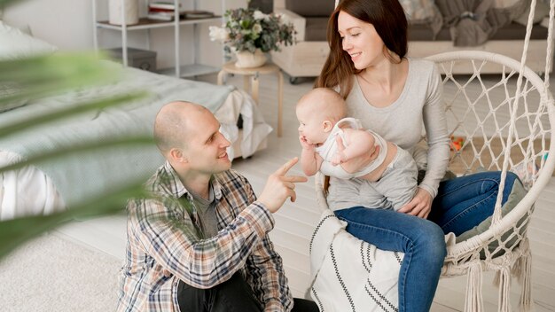 Front view of lovely parents with their kid