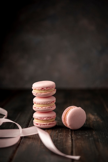 Free photo front view of macarons with ribbon and copy space