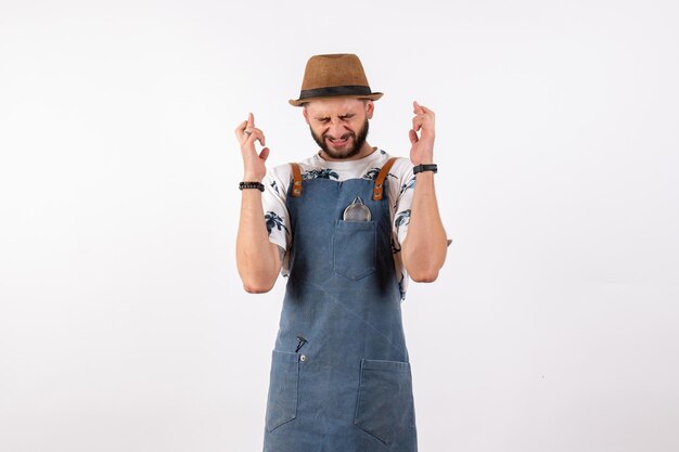 Front view male bartender crossing his fingers on white wall bar club night alcohol drink job model