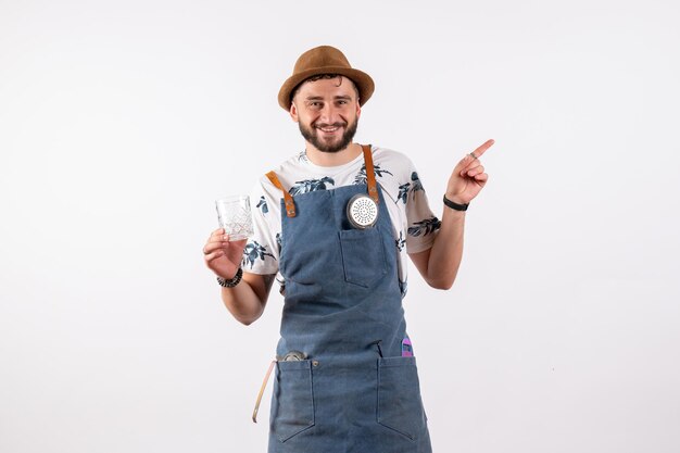 Front view male bartender holding glass on white wall alcohol club night drink job model bar nut