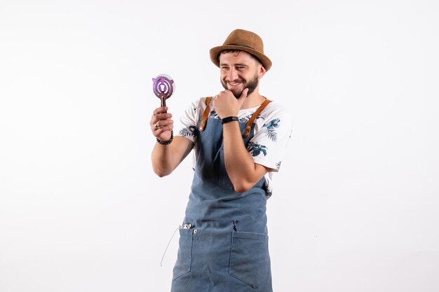 Front view male bartender holding nutcracker on white wall alcohol bar club night drink job model