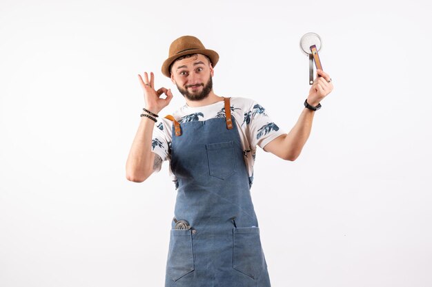 Front view male bartender holding nutcracker on white wall alcohol job club night drink bar nut