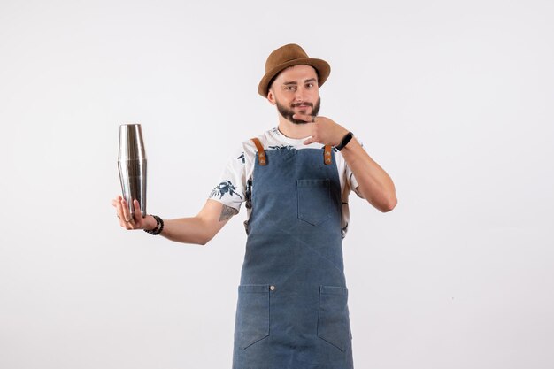 Front view male bartender holding shaker on the white wall club night job alcohol bar drink