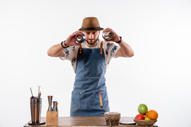 Front view male bartender holding shakers on white wall job bar alcohol club night drinks