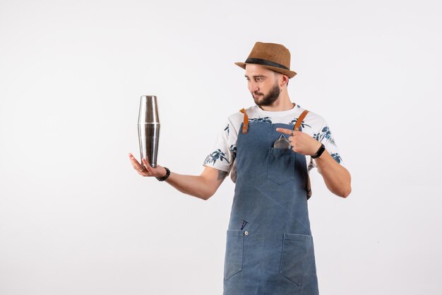 Front view male bartender holding silver shaker on the white wall alcohol bar club night drink job model