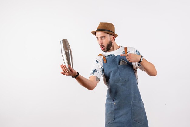 Front view male bartender holding silver shaker on white wall alcohol bar club night drinks job model