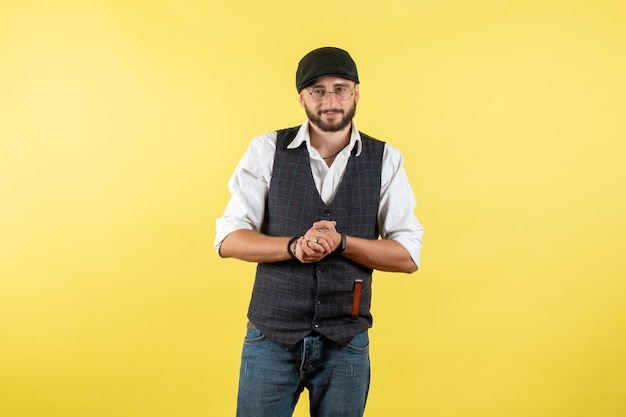 Front view male bartender just standing on yellow wall drink job club male night model work