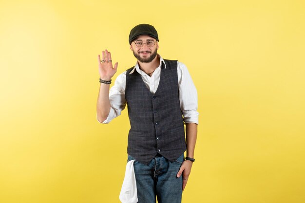 Front view male bartender smiling and greeting on yellow wall drink job club male night model work