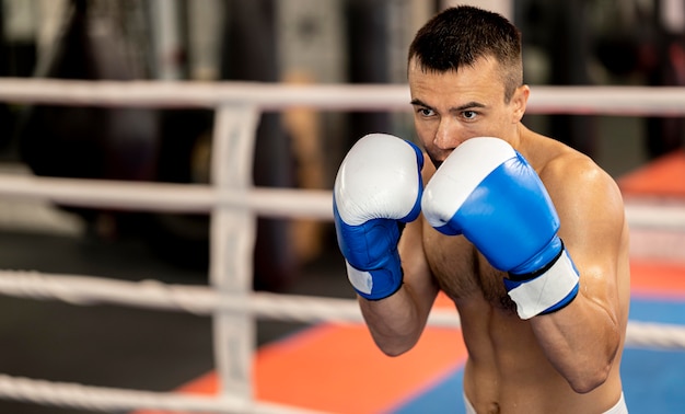 Front view of male boxer training in the ring