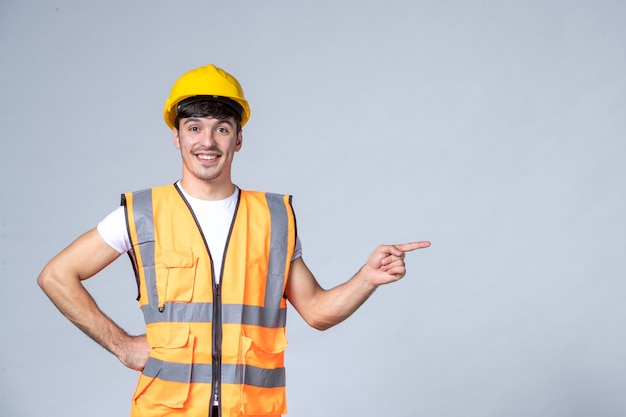 Free photo front view of male builder in uniform on white wall