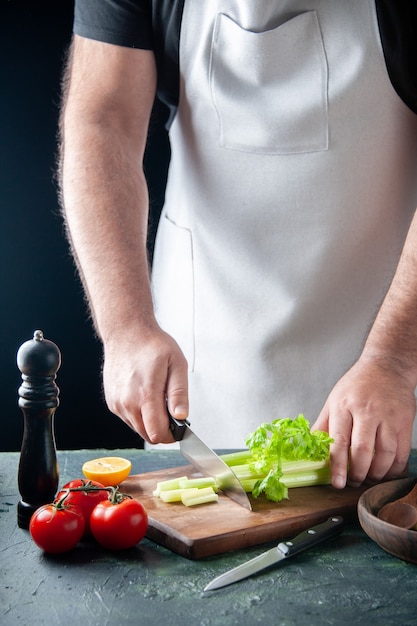 Free Photo front view male cook cutting celery on dark wall salad diet meal photo food health