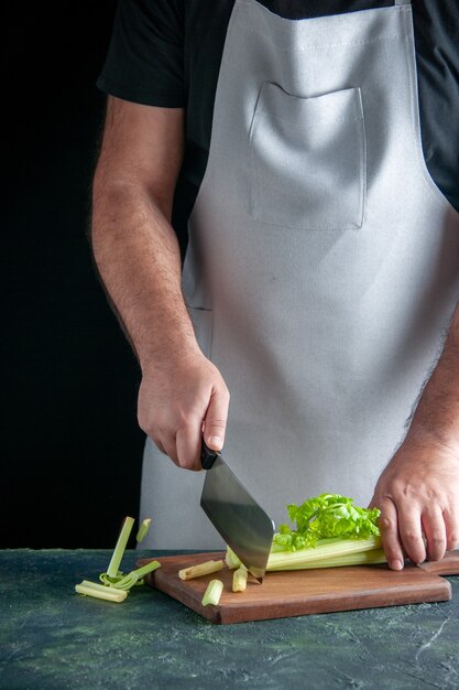 Front view male cook cutting celery on dark wall salad health diet meal colors photo food