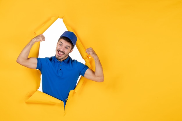 Free photo front view male courier in blue uniform on yellow space