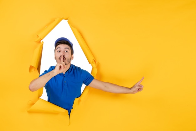 Free Photo front view male courier in blue uniform on yellow space