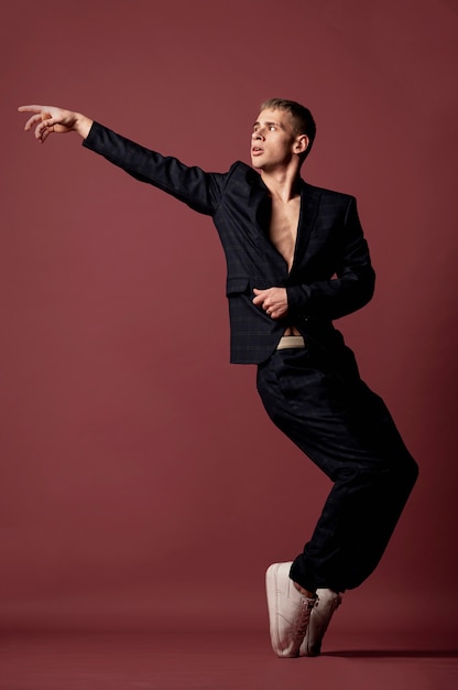 Free Photo front view of male dancing posing while showing classic toe standing move