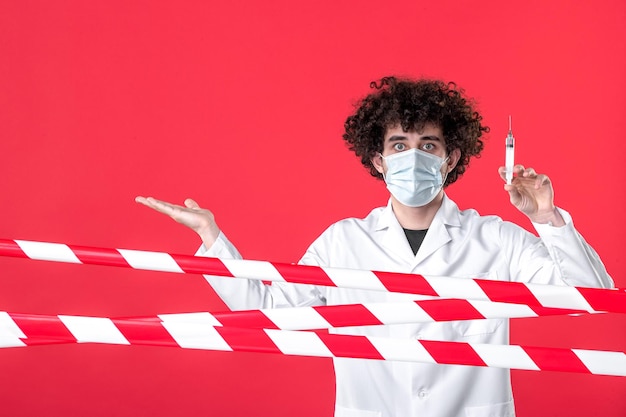 Free Photo front view male doctor preparing injection against virus on a red background warning covid- health medical quarantine hospital uniform