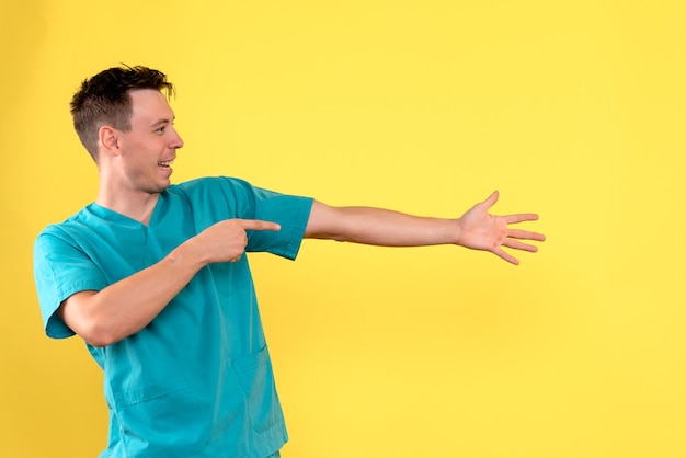 Free Photo front view of male doctor with excited expression on yellow wall