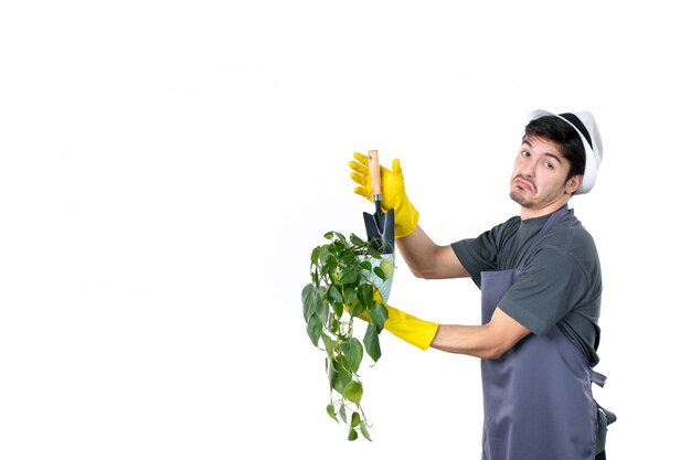 Front view male gardener holding little plant in pot and spatula on white background work ground tree flower grass job colors garden bush