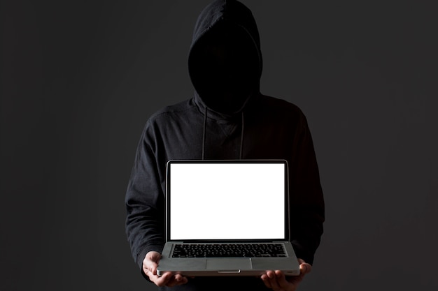 Free photo front view of male hacker holding laptop