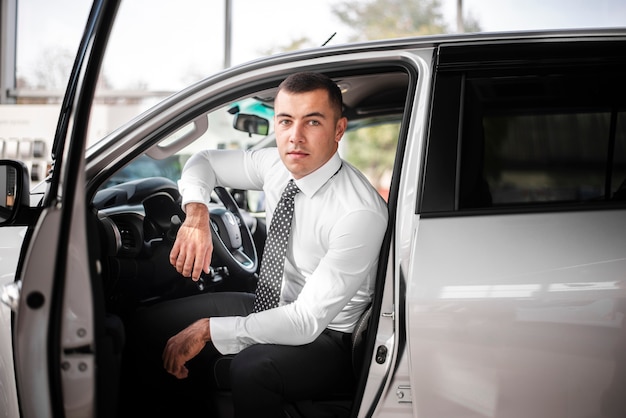 Free photo front view male inside car with door opened