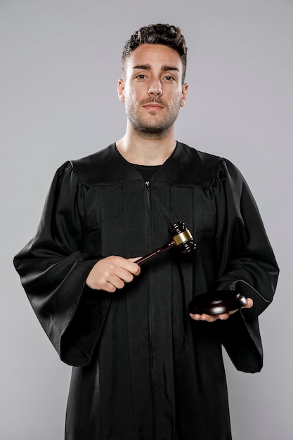 Free Photo front view of male judge posing with gavel