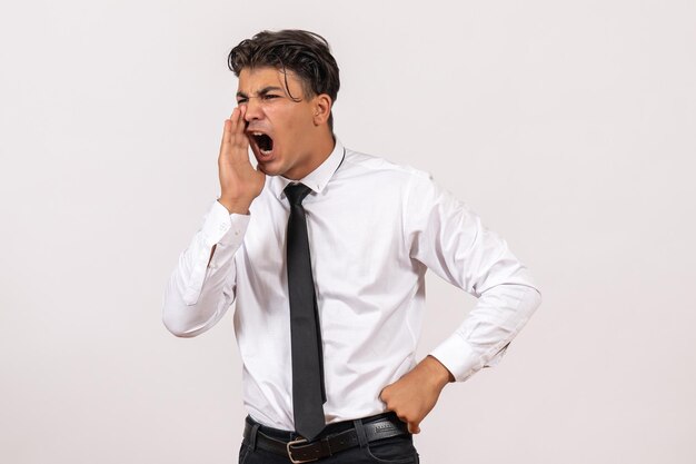 Front view male office worker calling on white wall work male job business