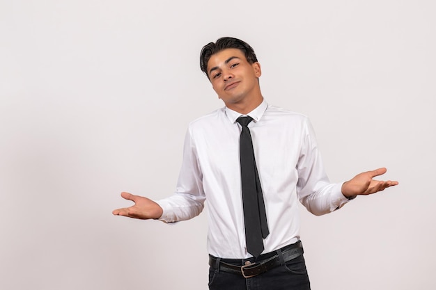 Front view male office worker posing on a white wall work male job business